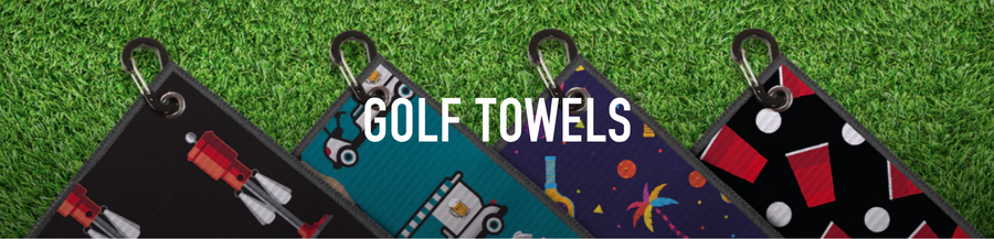 2UNDR Golf Towels in four printed designs with carabiner clips displayed on green grass background.